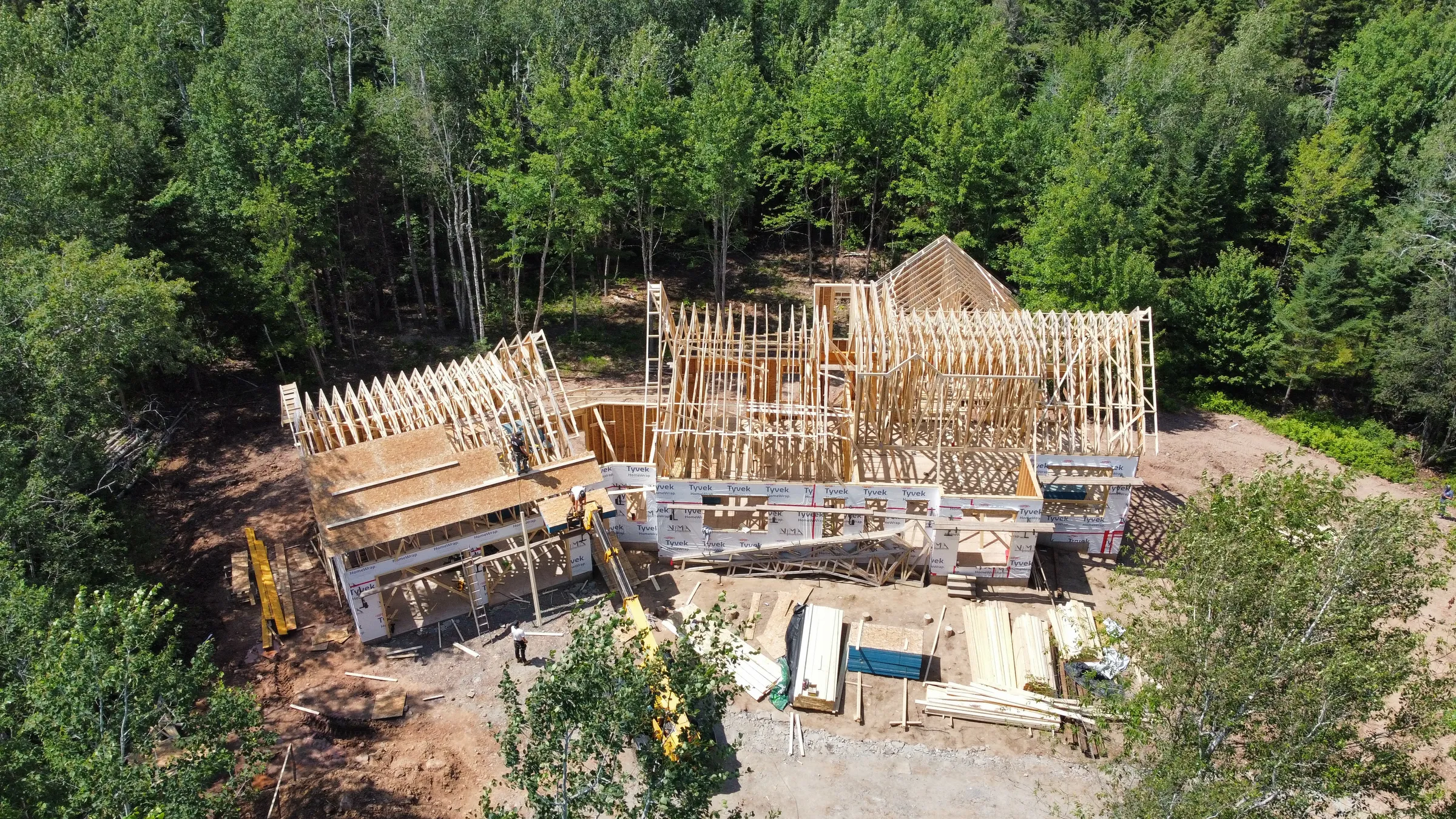 A home that is fully framed and the roof is being worked on