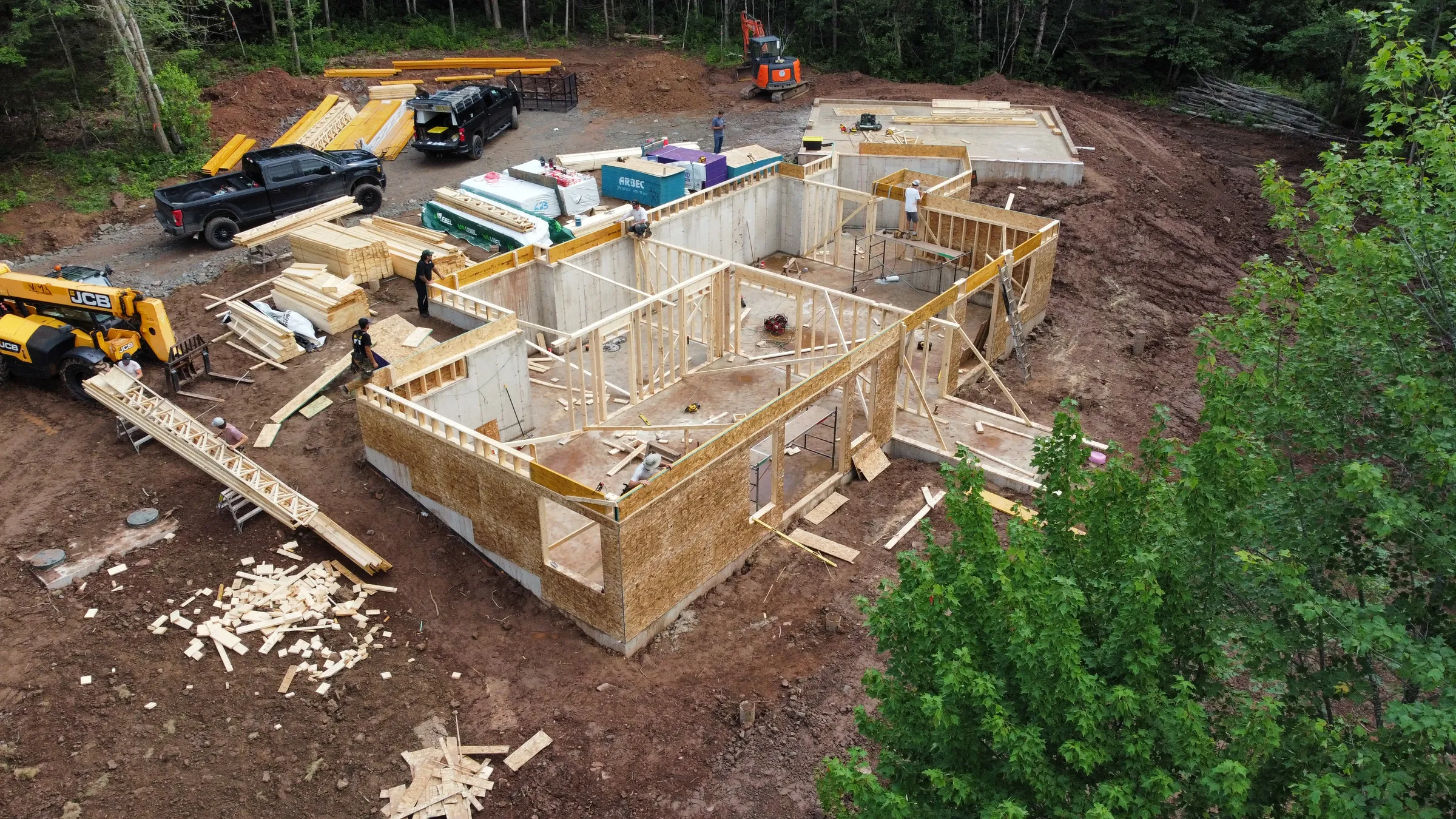 A to be built home with the framing up and contractors actively working